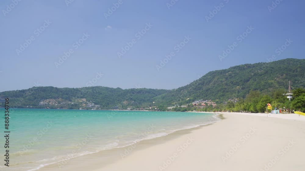 Beautiful Patong Beach famous tourist destination on a sunny day with clear blue waters and lush green hills in Phuket, Thailand. Beautiful Patong Beach famous tourist destination on a sunny day with clear blue waters and lush green hills in Phuket, Thailand.
