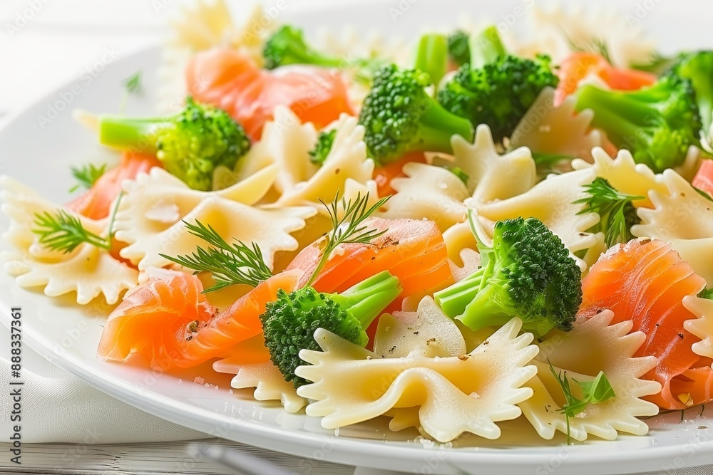 Homemade farfalle pasta salad with smoked salmon broccoli and spices for a tasty and healthy meal Symbolic image on a white background Homemade farfalle pasta salad with smoked salmon broccoli and spices for a tasty and healthy meal Symbolic image on a white background
