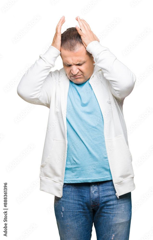 Middle age arab man wearing sweatshirt over isolated background suffering from headache desperate and stressed because pain and migraine. Hands on head.