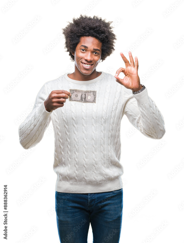 Afro american man holding one dollar over isolated background doing ok sign with fingers, excellent symbol Afro american man holding one dollar over isolated background doing ok sign with fingers, excellent symbol