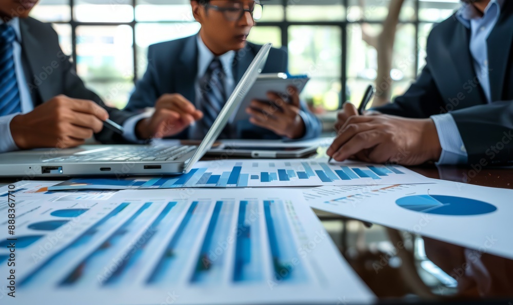 Financial team discussing quarterly results around a modern table Financial team discussing quarterly results around a modern table