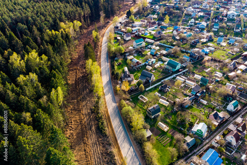 Picturesque dacha area with forest across the road, aerial view photo