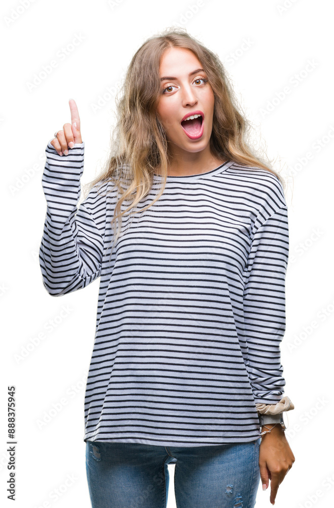 Beautiful young blonde woman wearing stripes sweater over isolated background pointing finger up with successful idea. Exited and happy. Number one.
