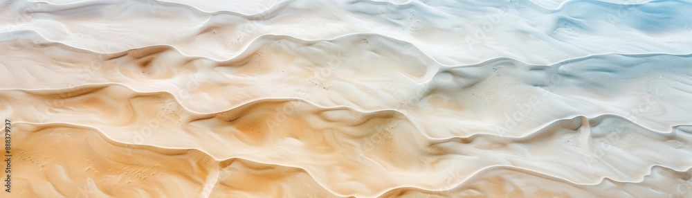 Abstract aerial view of wavy sand dunes showcasing beautiful patterns with gradient colors from beige to blue, perfect for creative backgrounds. Abstract aerial view of wavy sand dunes showcasing beautiful patterns with gradient colors from beige to blue, perfect for creative backgrounds.