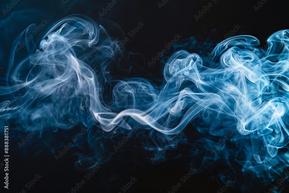 Fototapeta premium A blue smoke on a black background.