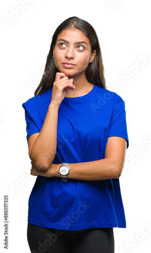 Young beautiful arab woman over isolated background with hand on chin thinking about question, pensive expression. Smiling with thoughtful face. Doubt concept. photo