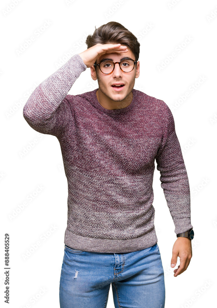 Young handsome man wearing glasses over isolated background very happy and smiling looking far away with hand over head. Searching concept.