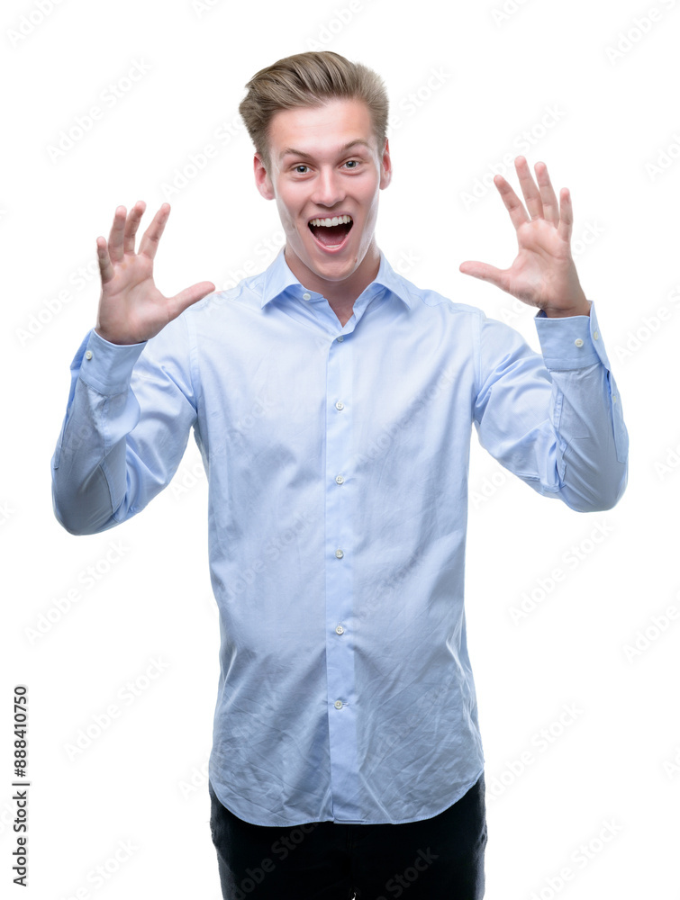 Young handsome blond man very happy and excited, winner expression celebrating victory screaming with big smile and raised hands Young handsome blond man very happy and excited, winner expression celebrating victory screaming with big smile and raised hands