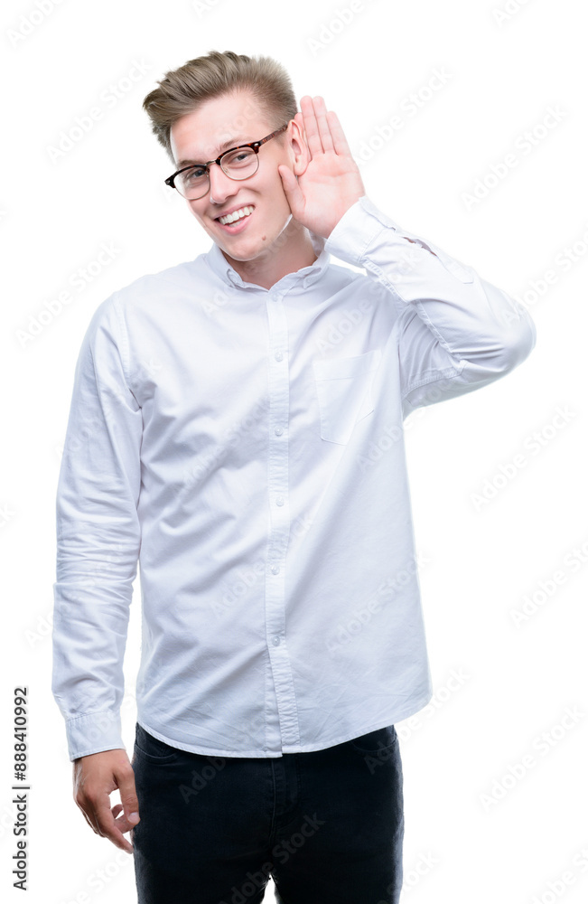 Young handsome blond man smiling with hand over ear listening an hearing to rumor or gossip. Deafness concept. Young handsome blond man smiling with hand over ear listening an hearing to rumor or gossip. Deafness concept.