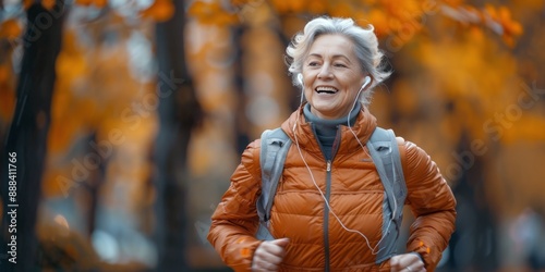 Senior Woman Jogging Through Autumn Foliage While Listening to Music