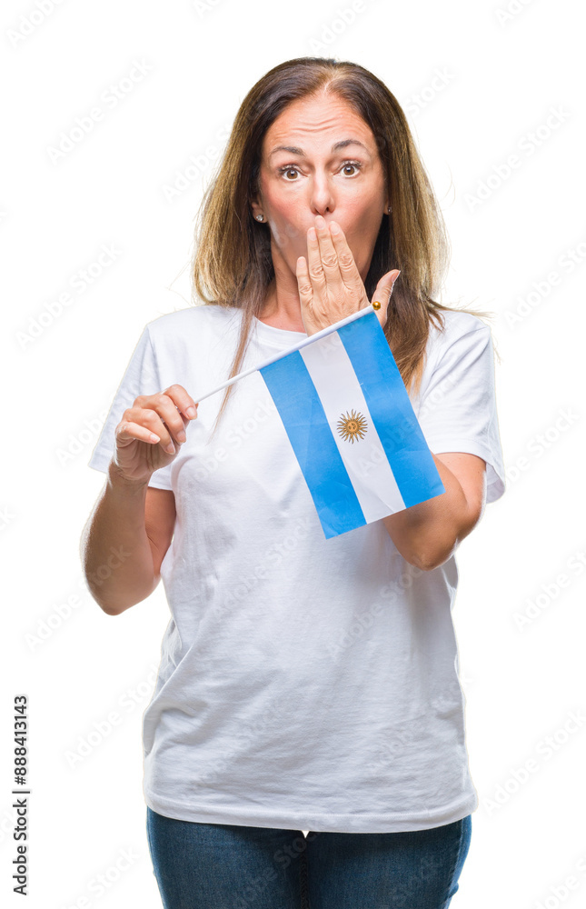 Middle age hispanic woman holding flag of Argentina over isolated background cover mouth with hand shocked with shame for mistake, expression of fear, scared in silence, secret concept Middle age hispanic woman holding flag of Argentina over isolated background cover mouth with hand shocked with shame for mistake, expression of fear, scared in silence, secret concept