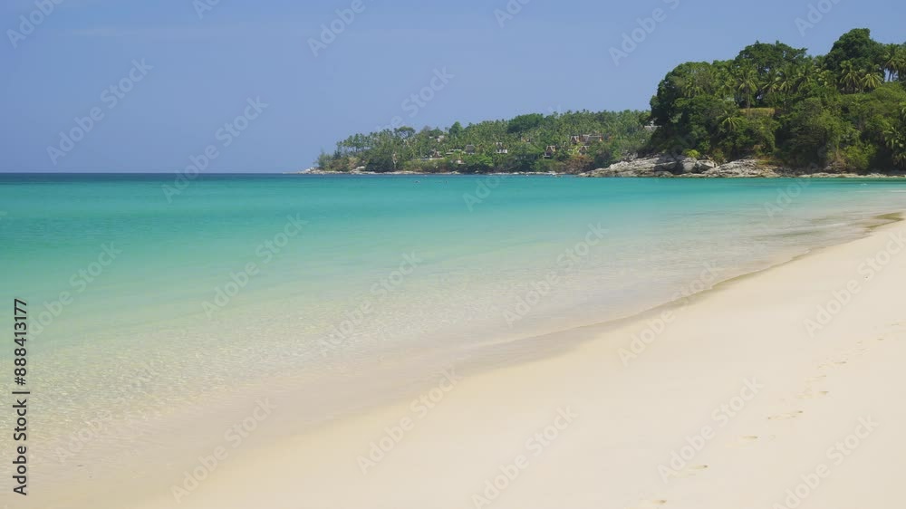 Serene Surin Beach with clear turquoise waters and pristine sands in Phuket, Thailand Serene Surin Beach with clear turquoise waters and pristine sands in Phuket, Thailand