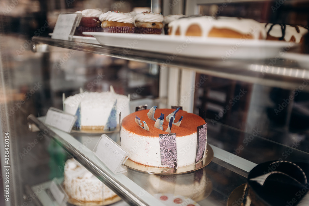 Assorted pastries and cakes are beautifully presented in the showcase of a bakery shop Assorted pastries and cakes are beautifully presented in the showcase of a bakery shop