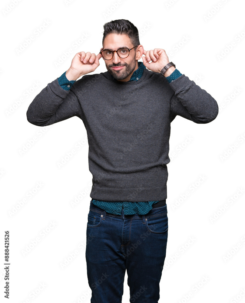 Fototapeta premium Young handsome man wearing glasses over isolated background Smiling pulling ears with fingers, funny gesture. Audition problem