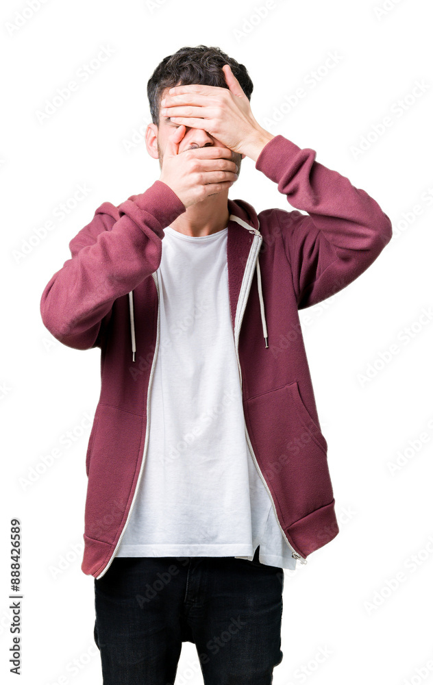 Fototapeta premium Young handsome man over isolated background Covering eyes and mouth with hands, surprised and shocked. Hiding emotion