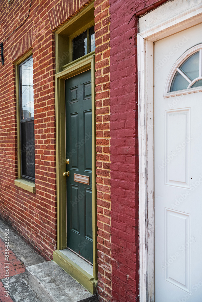 Entrance door to an ancient brick building. Entrance from the sidewalk to the apartment. Entrance door to an ancient brick building. Entrance from the sidewalk to the apartment.