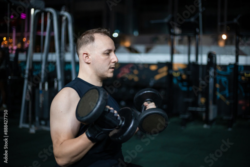 Man Lifting Weights During Evening Gym Workout