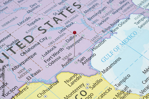 Close up to a Austin city with a red pin needle into United States of America country political map 