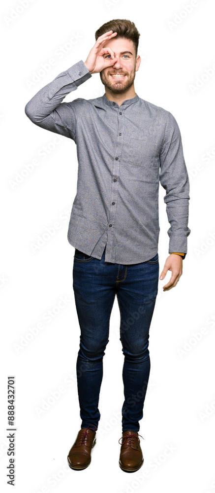 Young handsome business casual man doing ok gesture with hand smiling, eye looking through fingers with happy face. Young handsome business casual man doing ok gesture with hand smiling, eye looking through fingers with happy face.