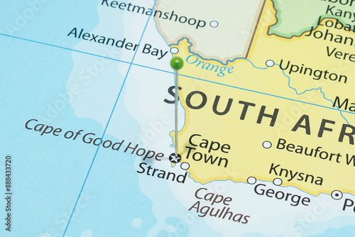 Macro photography of Cape Town city with a green pin needle into South Africa country political map 