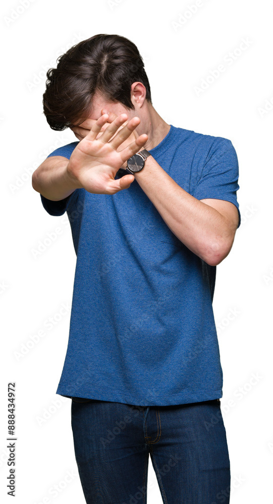 Young handsome man wearing blue t-shirt over isolated background covering eyes with hands and doing stop gesture with sad and fear expression. Embarrassed and negative concept.