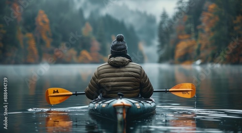 Solo Kayaking Through Autumn Forest on a Misty Day