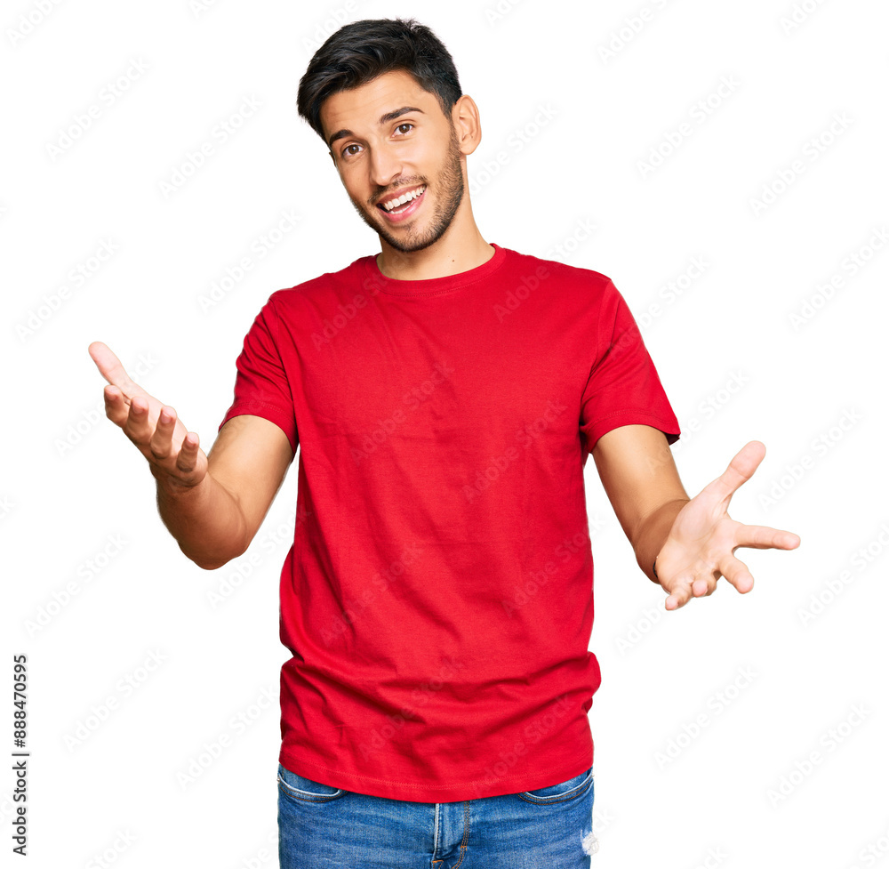 Young handsome man wearing casual red tshirt smiling cheerful offering hands giving assistance and acceptance. Young handsome man wearing casual red tshirt smiling cheerful offering hands giving assistance and acceptance.