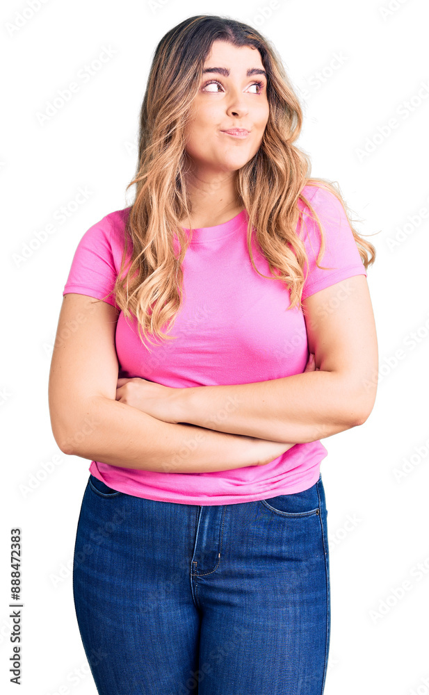 Young caucasian woman wearing sportswear smiling looking to the side and staring away thinking. Young caucasian woman wearing sportswear smiling looking to the side and staring away thinking.