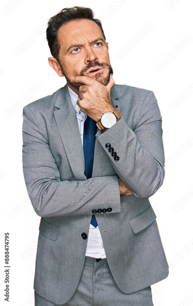 Middle age man wearing business clothes thinking worried about a question, concerned and nervous with hand on chin Middle age man wearing business clothes thinking worried about a question, concerned and nervous with hand on chin