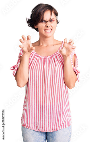 Beautiful young woman with short hair wearing casual summer clothes smiling funny doing claw gesture as cat, aggressive and sexy expression