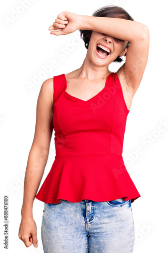 Beautiful young woman with short hair wearing casual style with sleeveless shirt covering eyes with arm smiling cheerful and funny. blind concept.