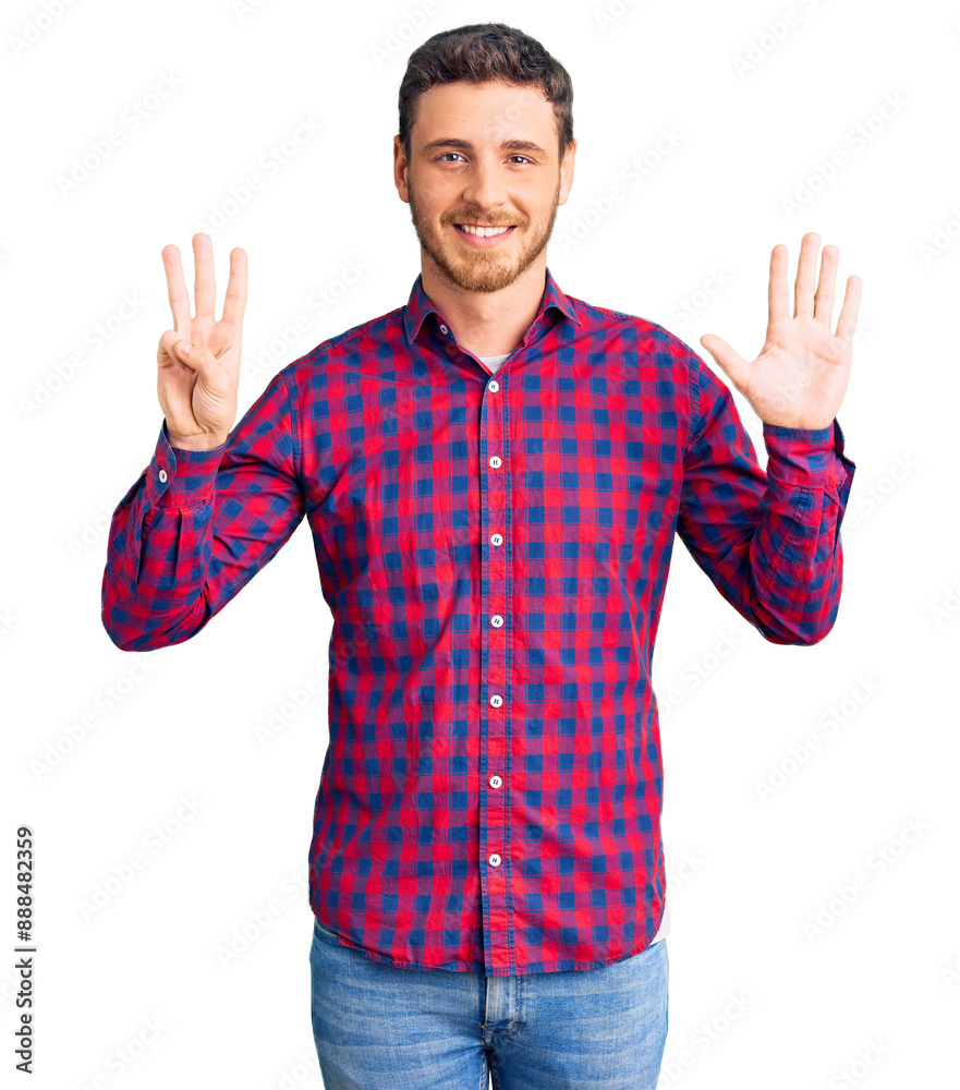 Naklejka premium Handsome young man with bear wearing casual shirt showing and pointing up with fingers number eight while smiling confident and happy.