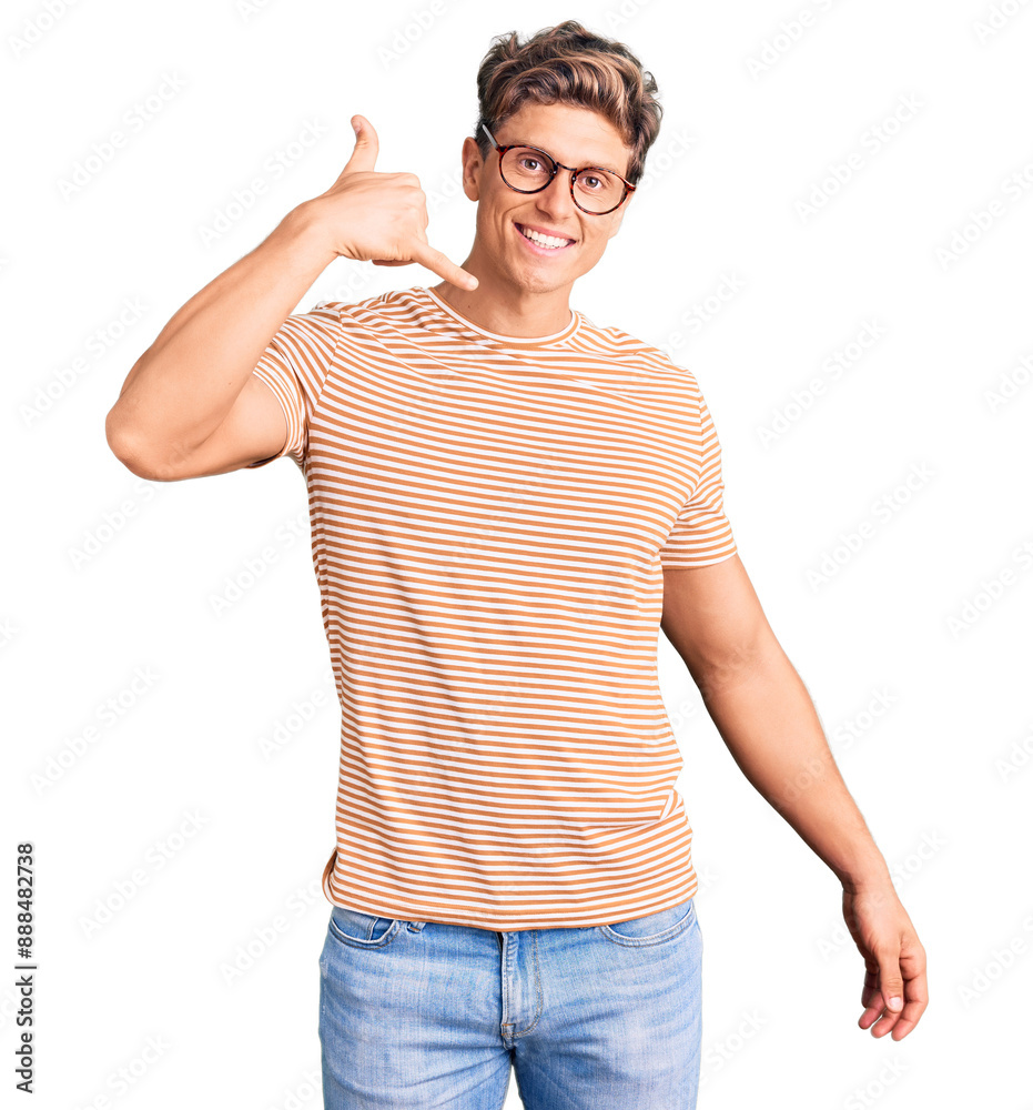 Young handsome man wearing casual clothes and glasses smiling doing phone gesture with hand and fingers like talking on the telephone. communicating concepts. Young handsome man wearing casual clothes and glasses smiling doing phone gesture with hand and fingers like talking on the telephone. communicating concepts.