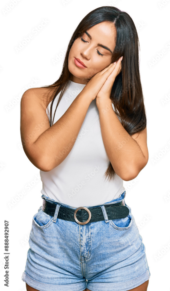 Young beautiful hispanic girl wearing casual clothes sleeping tired dreaming and posing with hands together while smiling with closed eyes. Young beautiful hispanic girl wearing casual clothes sleeping tired dreaming and posing with hands together while smiling with closed eyes.