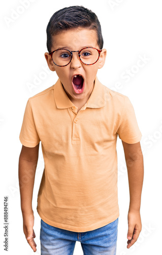 Little cute boy kid wearing casual clothes and glasses scared and amazed with open mouth for surprise, disbelief face