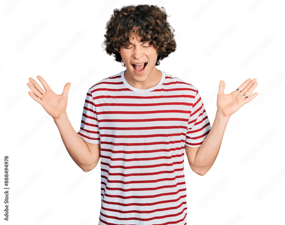 Caucasian teenager wearing casual clothes celebrating mad and crazy for success with arms raised and closed eyes screaming excited. winner concept Caucasian teenager wearing casual clothes celebrating mad and crazy for success with arms raised and closed eyes screaming excited. winner concept