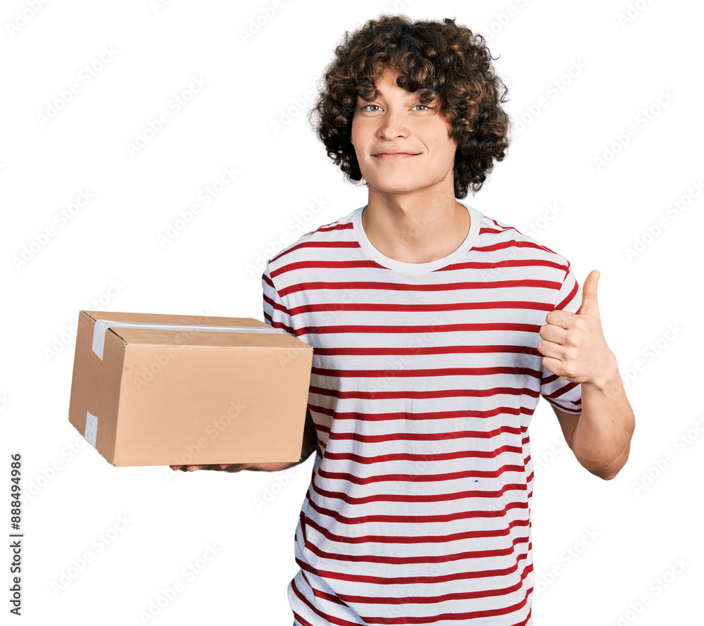 Φωτογραφία Caucasian teenager holding delivery package smiling happy and positive, thumb up