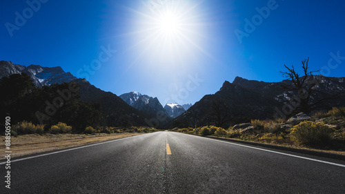 Wide shot from the road leading up to Mount Whitney, CA with the sun overhead