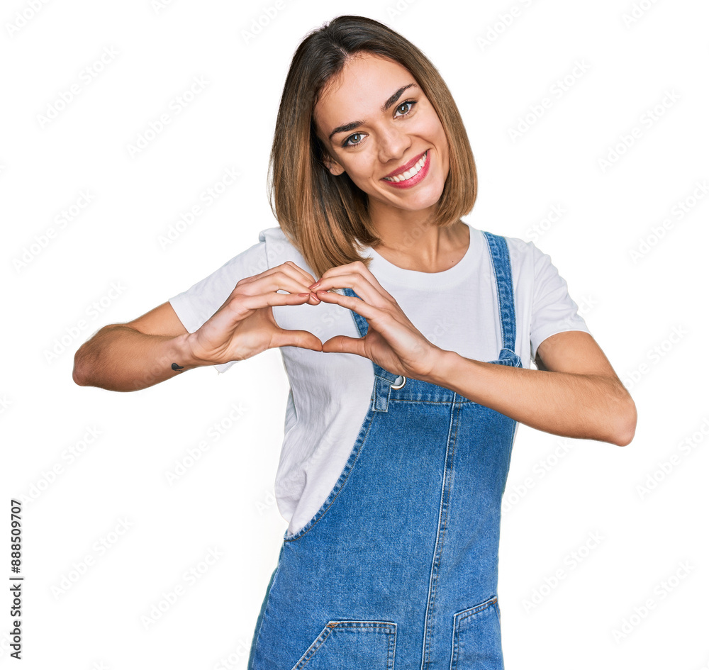 Young blonde girl wearing casual clothes smiling in love showing heart symbol and shape with hands. romantic concept.