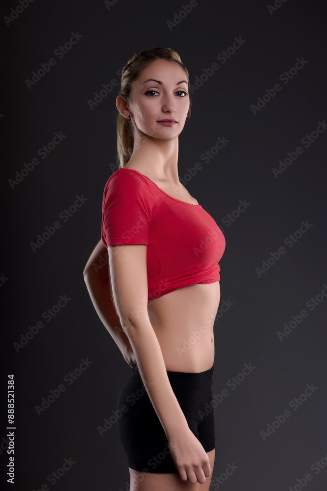 Obraz premium Young athletic woman posing showing her fit body after dieting