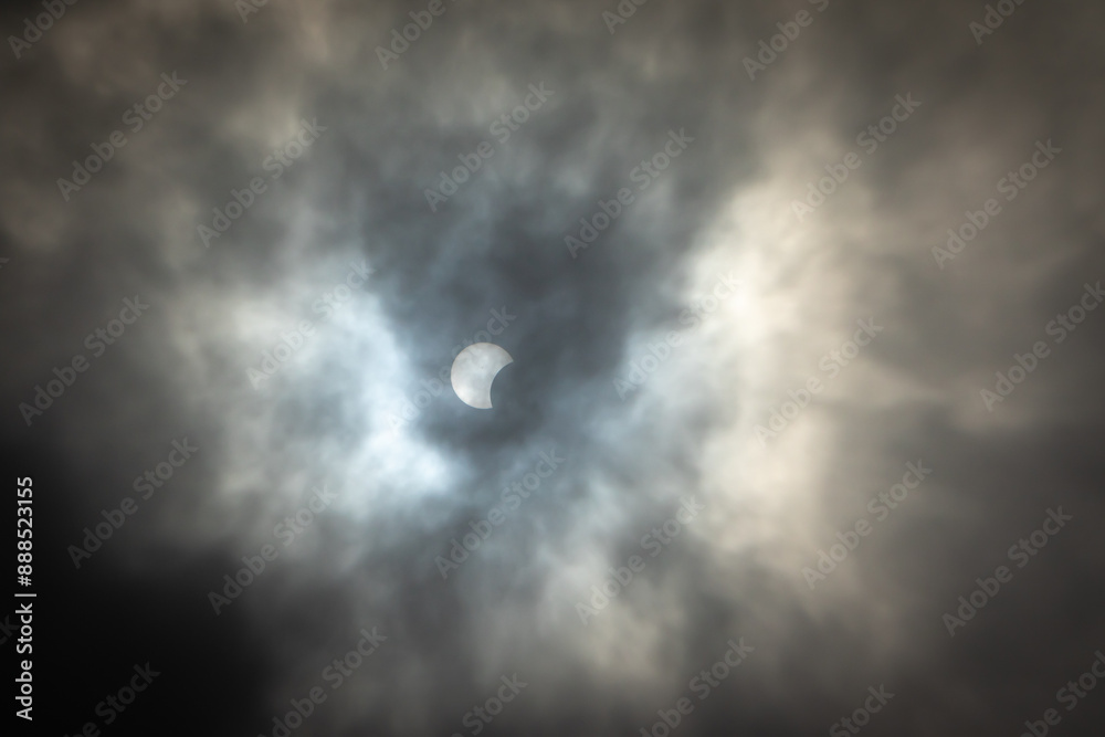 Solar eclipse nearing totality with darkening cloudy background Solar eclipse nearing totality with darkening cloudy background