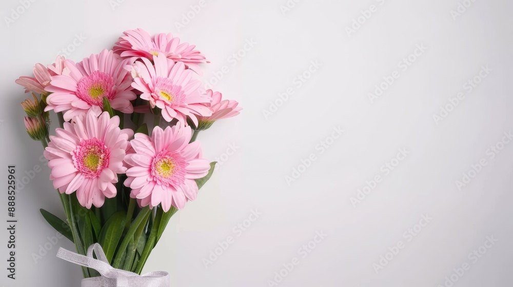 A bouquet of pink flowers is arranged in a vase A bouquet of pink flowers is arranged in a vase