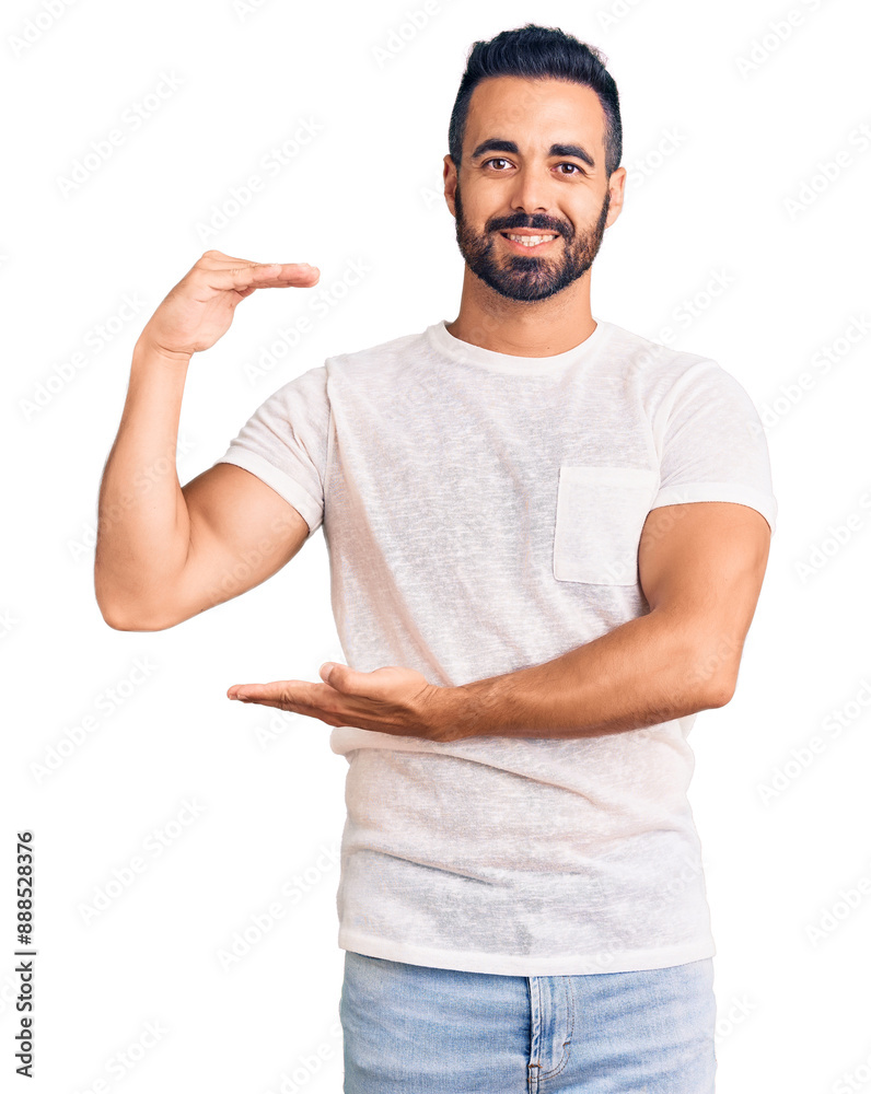 Young hispanic man wearing casual clothes gesturing with hands showing big and large size sign, measure symbol. smiling looking at the camera. measuring concept. Young hispanic man wearing casual clothes gesturing with hands showing big and large size sign, measure symbol. smiling looking at the camera. measuring concept.
