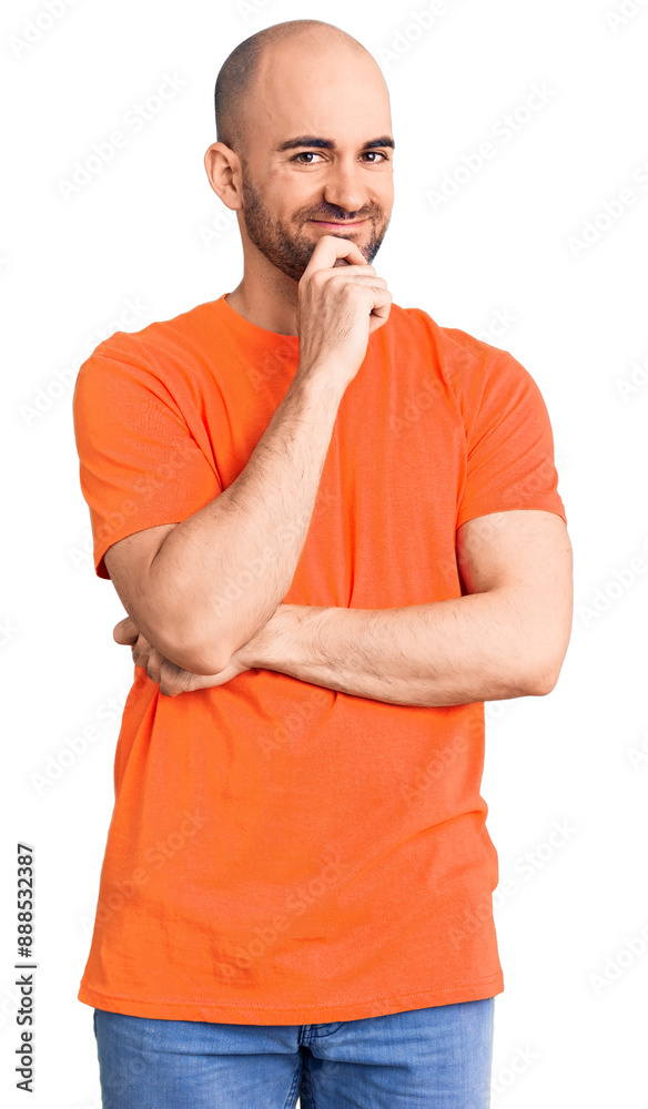 Young handsome man wering casual t shirt looking confident at the camera with smile with crossed arms and hand raised on chin. thinking positive. Young handsome man wering casual t shirt looking confident at the camera with smile with crossed arms and hand raised on chin. thinking positive.