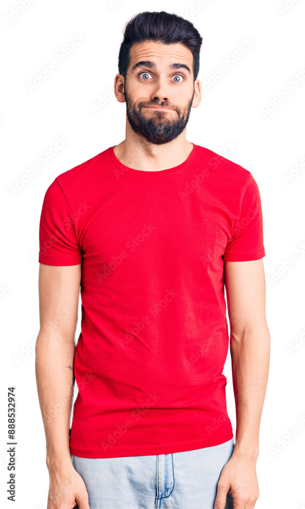 Young handsome man with beard wearing casual t-shirt puffing cheeks with funny face. mouth inflated with air, crazy expression. Young handsome man with beard wearing casual t-shirt puffing cheeks with funny face. mouth inflated with air, crazy expression.