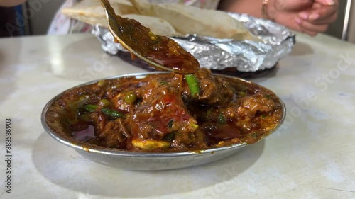 Spciy mutton curry prepared in Indian style served with tandoori roti. photo