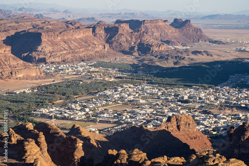 Obraz na płótnie Al Ula, Saudi Arabia: Dramatic panoramic view of the Al Ula landscape famous for its red desert and rock formations and heritage sites in Saudi Arabia from the top of Mt Harrat w salonie