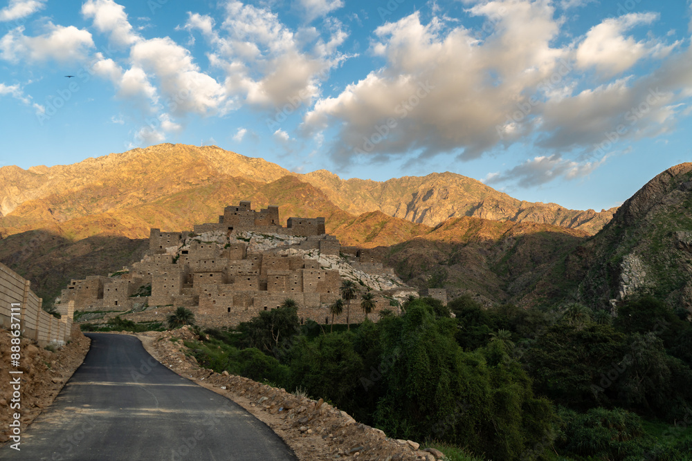Al Bahah, Saudi Arabia: The road toward the Thee Ain, or Zee Ain ancient village in the mountains of Saudi Arabia in late afternoon with a cloudy blue sky