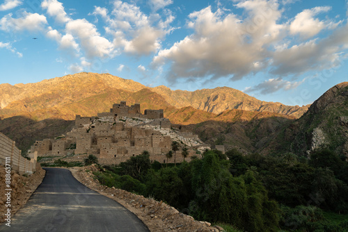 Obraz na płótnie Al Bahah, Saudi Arabia: The road toward the Thee Ain, or Zee Ain ancient village in the mountains of Saudi Arabia in late afternoon with a cloudy blue sky w salonie
