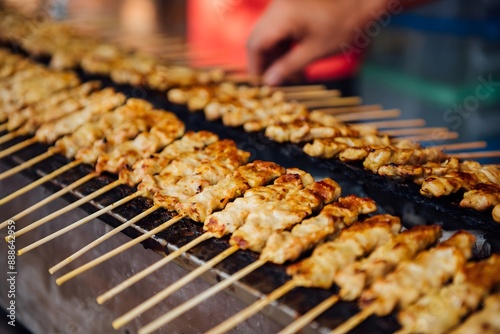 Close up Pork Satay with The sauce is delicious with cucumber on the wooden table served.